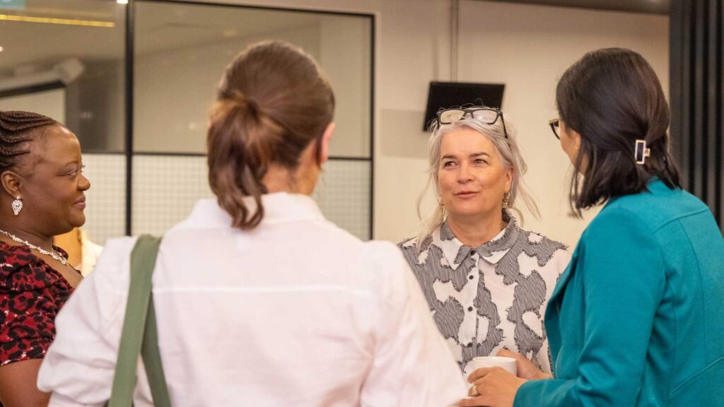 Woman talking to a group of other women